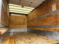 A 2021 Mitsubishi FE truck with an empty cargo area featuring wooden floors and paneling along the sides