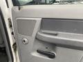 Close-up of the interior driver's side door panel of a 2008 Dodge Ram 5500 featuring a speaker grille door handle and window controls