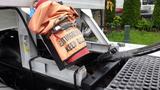 A fire extinguisher mounted on a 2019 Western Star Trucks 4900 with an orange cover that says Extinguisher Keep Clear