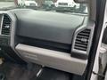 The interior dashboard of a 2016 Ford F-150 featuring a glove compartment and air vents