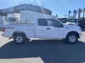 A white 2019 Ford F-150 pickup truck with a short bed and four-wheel drive visible from the side