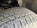A close-up view of a tire on a 2021 Ford F-150 showcasing the tread pattern and texture