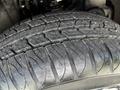 Close-up of a tire tread from a 2021 Chevrolet Colorado showing detailed patterns and grooves designed for traction and grip
