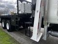 A 2008 International 7500 truck featuring a flatbed design with large tires and metal step ladder for access to the cargo area