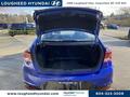 A 2020 Hyundai Elantra with its trunk open showcasing its spacious cargo area