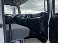 Interior of a 2019 Hino 338 24 foot cube truck showing the driver's seat dashboard and control panel with a gray fabric seat