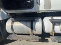 Close-up of the fuel tanks and steps on a 2014 International 7400 truck showing cylindrical silver tanks and black metal steps