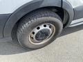 A close-up of a tire on a 2019 Ford Transit showcasing the rugged tread pattern and wheel rim