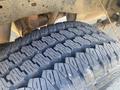 Close-up of a rugged tire tread on a 2014 Ford F-250 SD showcasing deep grooves designed for traction on various terrains