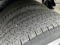 A close-up of a tire from a 2021 Ford E-450 showcasing the detailed tread pattern and sidewall design