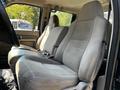 Interior of a 2008 Ford F-550 showing two cloth front seats with a gray pattern and seatbelt buckles visible