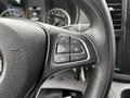 Close-up of the steering wheel of a 2020 Mercedes-Benz Metris featuring control buttons for phone and audio functions