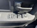 Close-up of the control panel for power windows and locks in a 2019 RAM 1500 Classic with various buttons and a textured surface