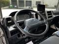 Interior view of a 2020 Hino 338 truck showing the steering wheel dashboard gauges and a mounted display screen