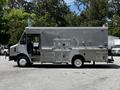 A silver 2008 Morgan Olson Workhorse delivery truck with side doors and a sleek design parked on a paved area