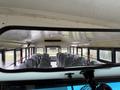 Interior view of a 2016 International CE300 school bus showing rows of gray seats and overhead features