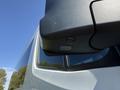 A close-up of the side mirror and camera system on a 2023 Mercedes-Benz Sprinter van