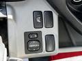 A close-up view of the control panel in a 2018 Hino 195 featuring buttons for heater, mirror adjustment, and left-right options for the mirrors