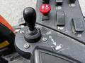 Close-up of the controls of a 2015 Jacobsen Eclipse featuring a joystick and various buttons and levers for operation and adjustments