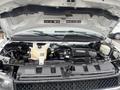 Engine compartment of a 2016 Chevrolet Express with visible components including the engine, coolant reservoir and various hoses and wiring