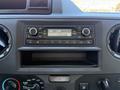 Dashboard of a 2021 Ford Econoline featuring a car radio with a digital display and control knobs