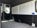 Interior view of a 2019 Mercedes-Benz Sprinter van showcasing a spacious cargo area with gray flooring and black paneling along the walls