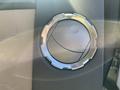 A chrome circular vent cover from a 2014 Ford F-350 SD with a textured background and a sleek design