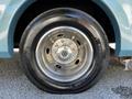 Close-up of a shiny chrome wheel on a 2000 Ford Motorhome featuring a black tire with clear tread pattern and the brand logo visible
