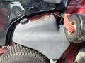 Close-up of a 2014 Toro Groundmaster 5910 showing the engine cover and tire with a fuel cap visible on the engine compartment