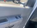 A close-up of the interior door panel of a 2009 Ford Econoline showing window controls and textured surface details