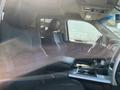 Interior of a 2011 RAM 1500 featuring two front leather seats a central armrest console and dashboard controls