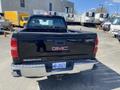 Black 2014 GMC Sierra 1500 pickup truck viewed from the rear with a visible GMC logo and license plate
