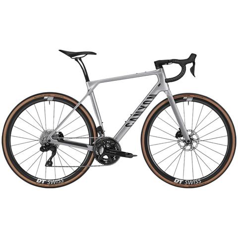 A 2025 Canyon Endurace CF 7 Di2 road bike featuring a sleek gray frame disc brakes and tan sidewall tires designed for performance and comfort