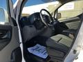 Interior view of a 2017 Nissan NV200 showing the driver's seat steering wheel and dashboard with floor mat displaying a thank you message