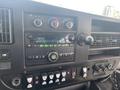 Dashboard controls of a 2017 Chevrolet Express featuring audio system knobs buttons for climate and various vehicle functions