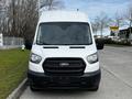 Front view of a 2020 Ford Transit van with a white exterior and black grille located in a parking area