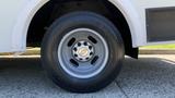 A close-up view of a silver wheel from a 2011 Chevrolet Express featuring a five-spoke design and branded center cap with the Chevrolet logo