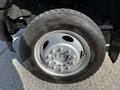 A close-up of a tire and wheel on a 2018 Ford F-550 showing the chrome rim and black tire tread
