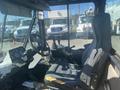Interior view of a 2010 Trackless MT6 featuring a driver's seat control panel and steering wheel with visible gauges and equipment controls