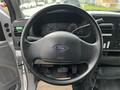 Steering wheel of a 2007 Ford F-550 with a Ford logo in the center and dashboard controls visible behind it