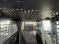 The interior of a 2016 Chevrolet Tahoe features a security partition with perforated metal panels and a slick black surface