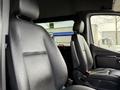 Interior view of a 2019 Mercedes-Benz Sprinter showing two black leather seats with headrests and armrests