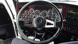 The interior dashboard of a 2019 Western Star Trucks 4900 showing an array of gauges and a steering wheel