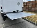 A silver loading dock liftgate extended from the rear of a 2006 Hino 268 truck