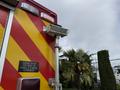A 2007 Ford F-550 ambulance with a red and yellow striped design and an emergency light mounted on the rear side