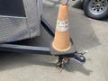 A 2020 Stealth Enterprises Trailer with a black tow hitch and an orange traffic cone placed on top of the hitch platform