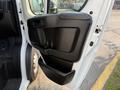 A 2017 RAM Promaster door showing the interior handle controls and a storage pocket on the lower part of the door