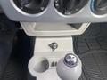 The image shows the interior of a 2007 Chrysler PT Cruiser featuring the gear shift, cup holder, and control knobs for climate settings