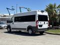 A white 2016 RAM Promaster van parked with large windows and commercial design features