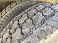 Close-up of two rugged tires with deep treads showcasing wear and tear typical for off-road use on a 2014 International TerraStar